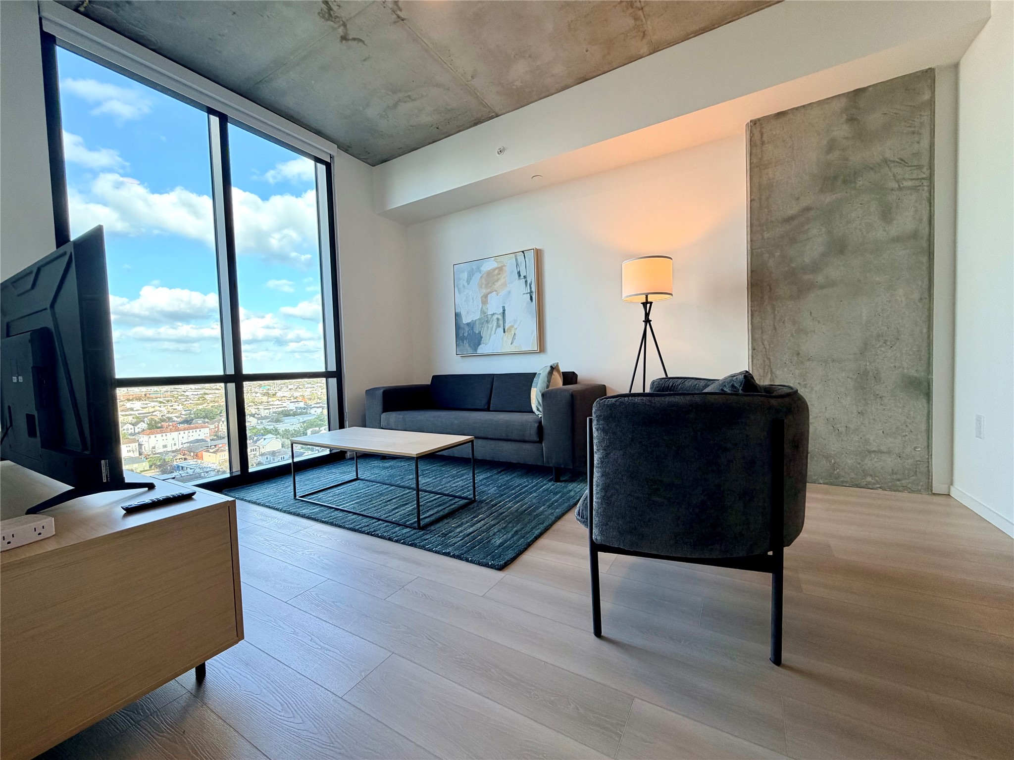5501 La Branch Street, Unit 2108 Houston, TX 77004 - Photo 3 of 12 a living room with furniture wooden floor and a large window