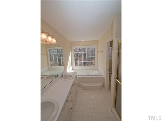 12400 Glenlivet Way Raleigh, NC 27613 - Photo 16 of 24 This Master Bath / Spa Room has Double Vanities, a Step Up Tub, Private Shower and more. Large Window over-looks the Private Backyard. This area was also recently painted. Master Bath/Spa