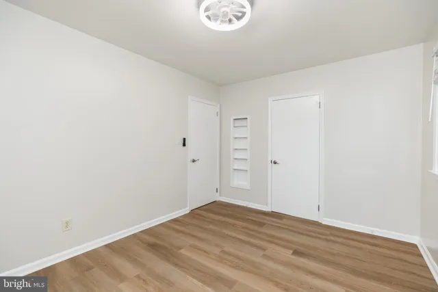 a view of a room with wooden floor