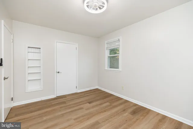 a view of a room with wooden floor and window