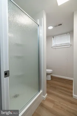 a bathroom with a glass shower door