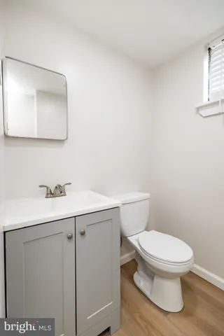 a bathroom with a toilet a sink and mirror