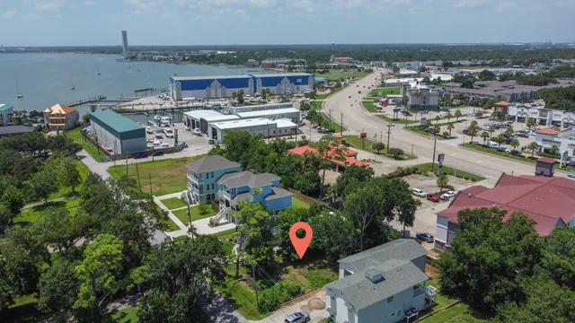 an aerial view of a house with a yard and lake view
