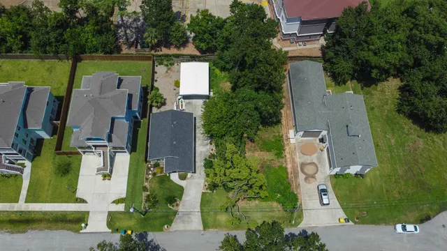 an aerial view of a house with a garden and a yard