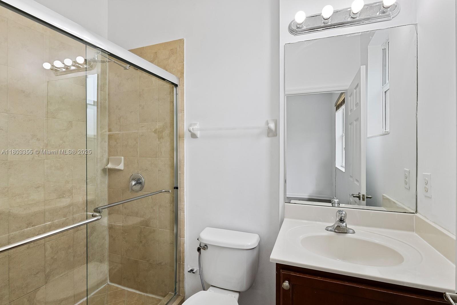 9153 Southwest 227th Street, Unit 3 Cutler Bay, FL 33190 - Photo 13 of 32 a bathroom with a sink toilet and shower