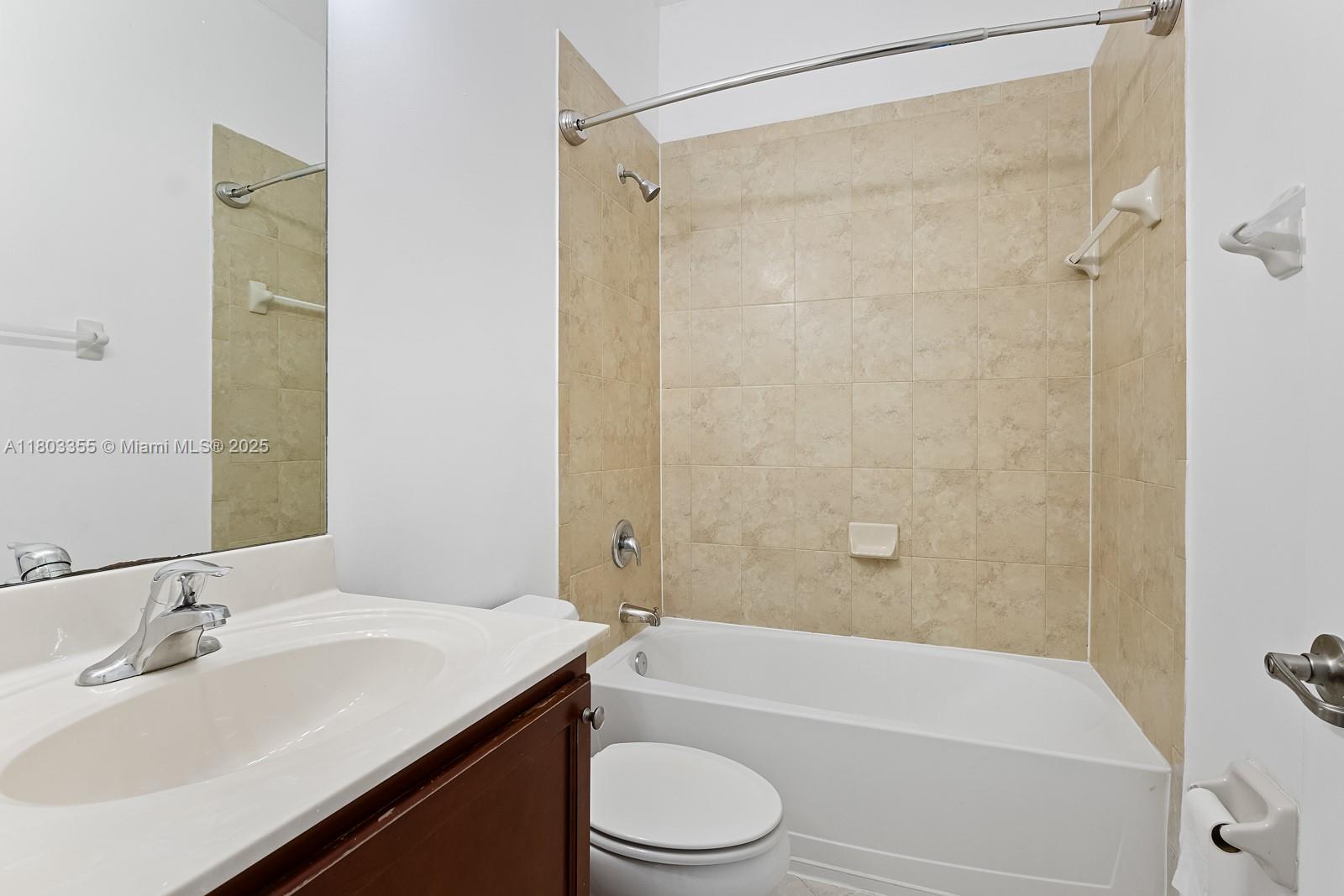 9153 Southwest 227th Street, Unit 3 Cutler Bay, FL 33190 - Photo 16 of 32 a bathroom with a sink a toilet and a bathtub