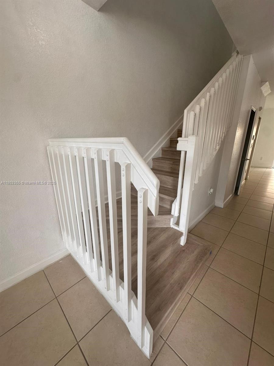 9153 Southwest 227th Street, Unit 3 Cutler Bay, FL 33190 - Photo 17 of 32 a view of a livingroom with stairs