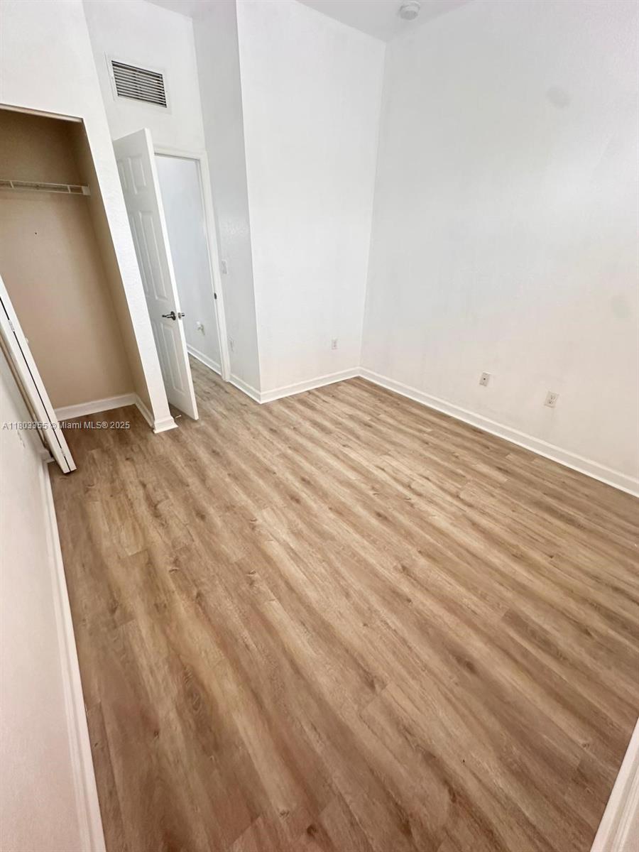 9153 Southwest 227th Street, Unit 3 Cutler Bay, FL 33190 - Photo 20 of 32 a view of empty room with wooden floor