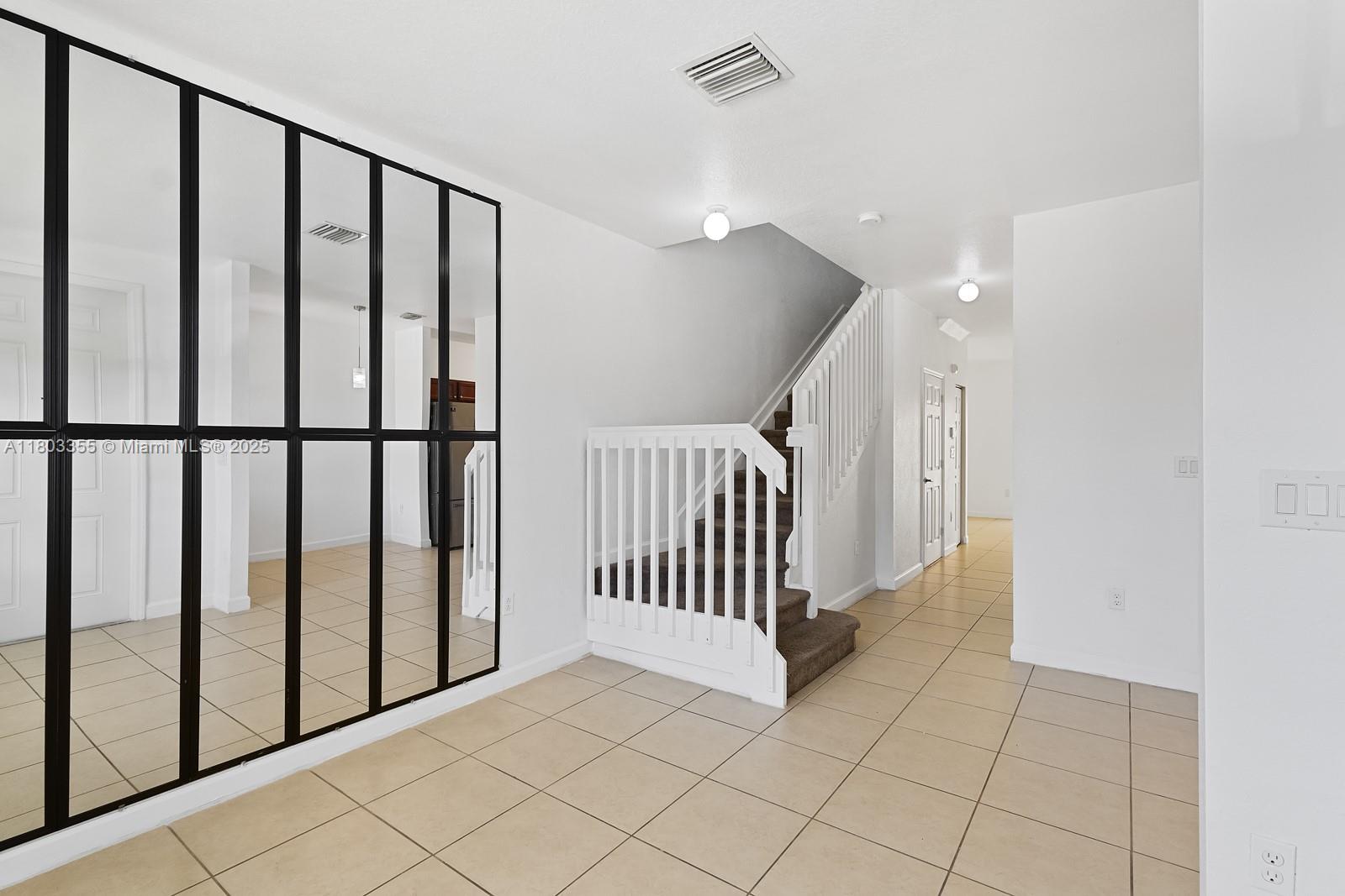 9153 Southwest 227th Street, Unit 3 Cutler Bay, FL 33190 - Photo 2 of 32 a view of a hallway with staircase