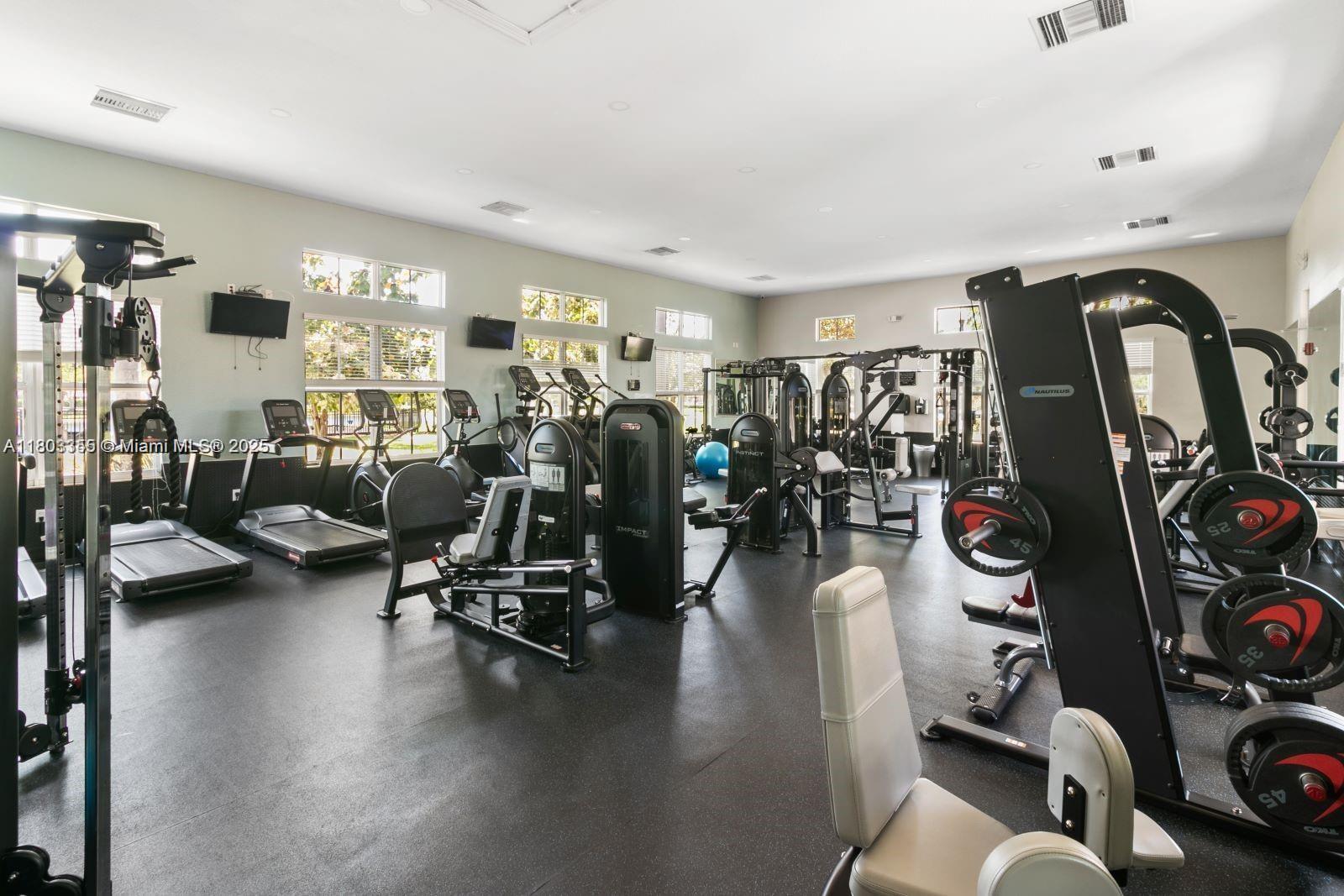9153 Southwest 227th Street, Unit 3 Cutler Bay, FL 33190 - Photo 25 of 32 a view of a room with gym equipment