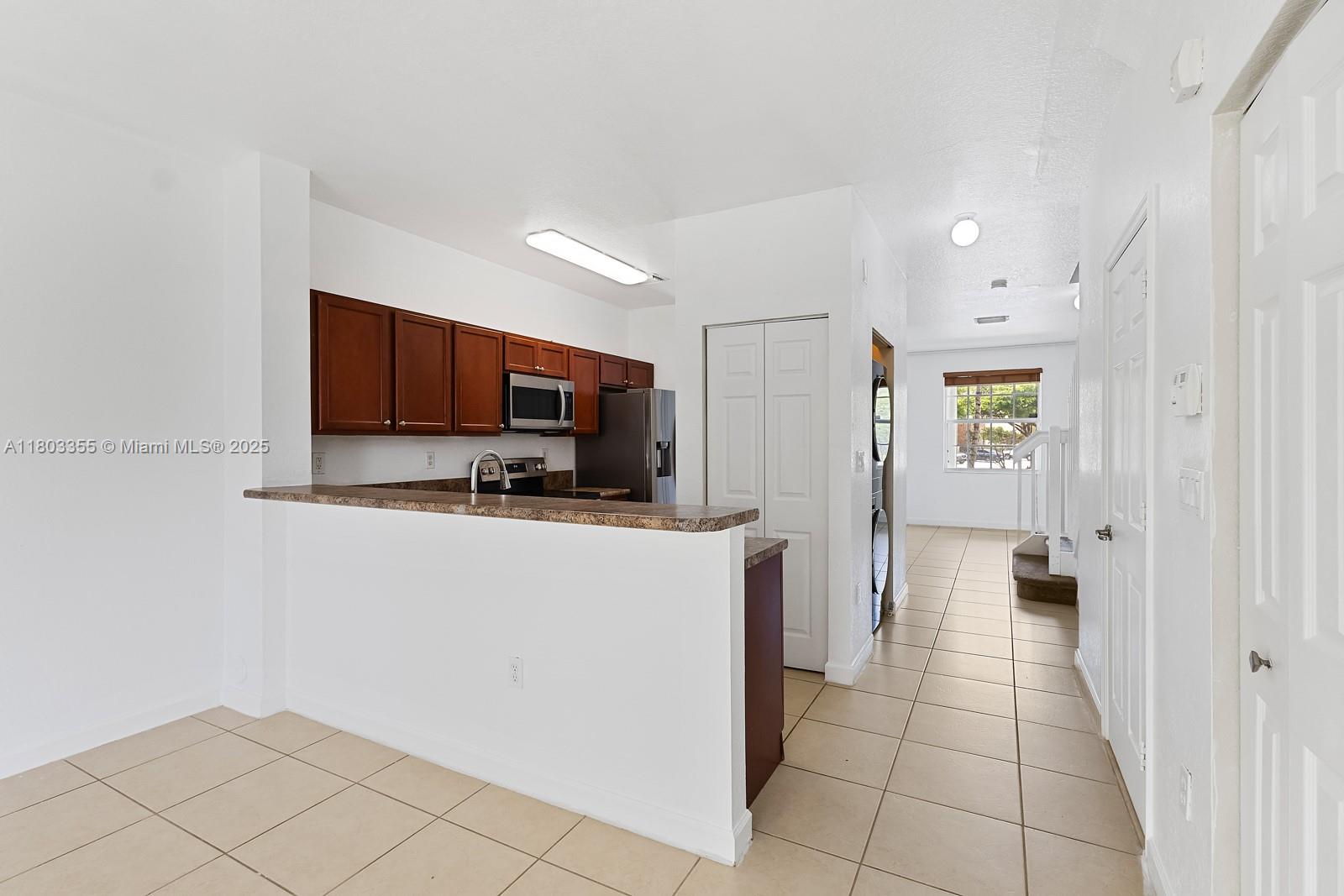9153 Southwest 227th Street, Unit 3 Cutler Bay, FL 33190 - Photo 4 of 32 a kitchen with stainless steel appliances a refrigerator and a microwave