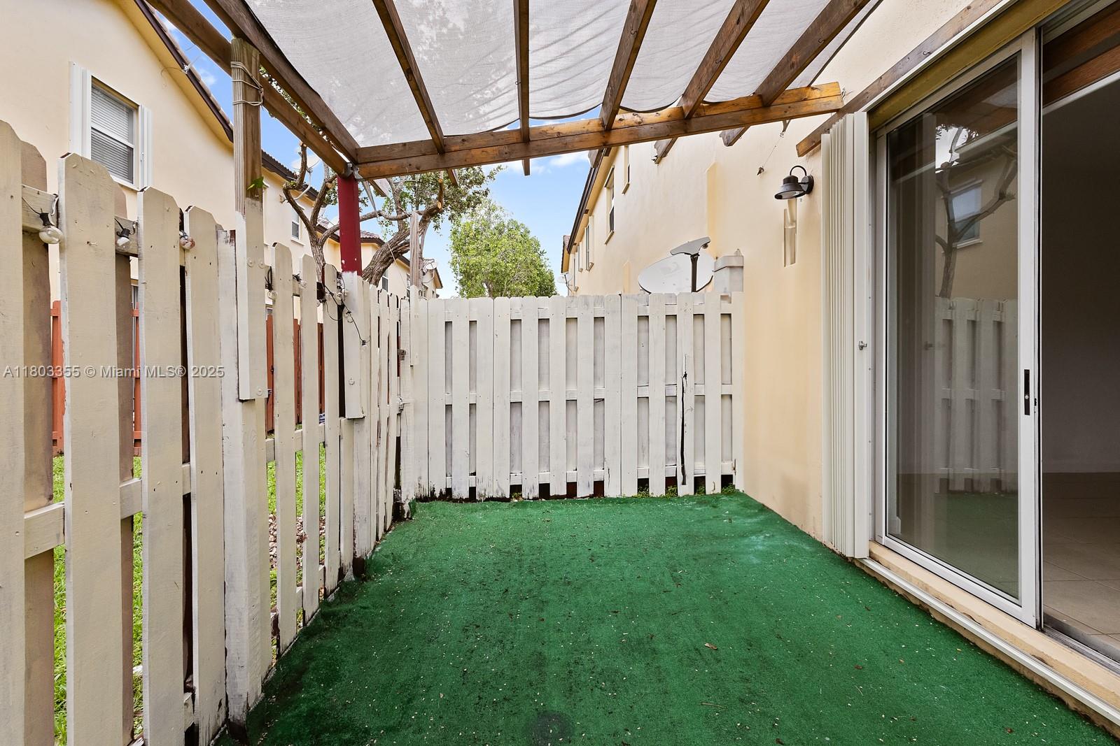9153 Southwest 227th Street, Unit 3 Cutler Bay, FL 33190 - Photo 6 of 32 a view of a pathway of a house with wooden floor