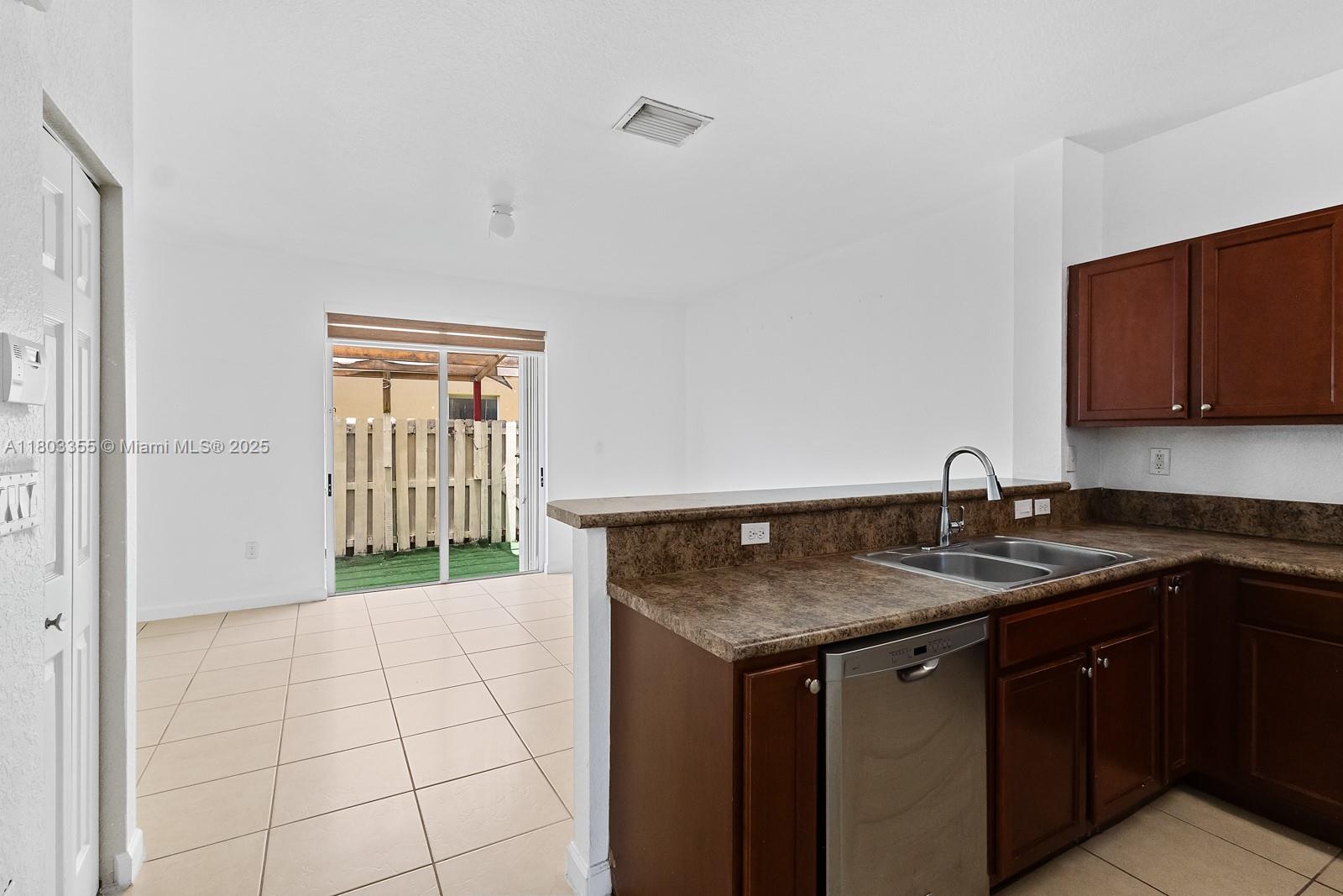 9153 Southwest 227th Street, Unit 3 Cutler Bay, FL 33190 - Photo 8 of 32 a kitchen with a sink and cabinets