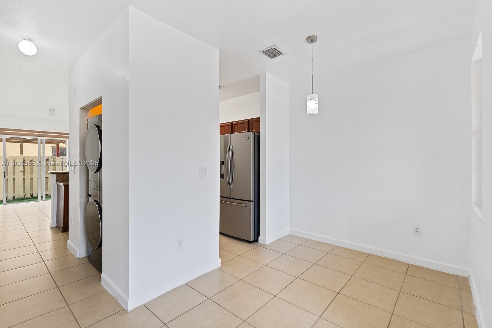 9153 Southwest 227th Street, Unit 3 Cutler Bay, FL 33190 - Photo 9 of 32 a view of a storage & utility room with refrigerator