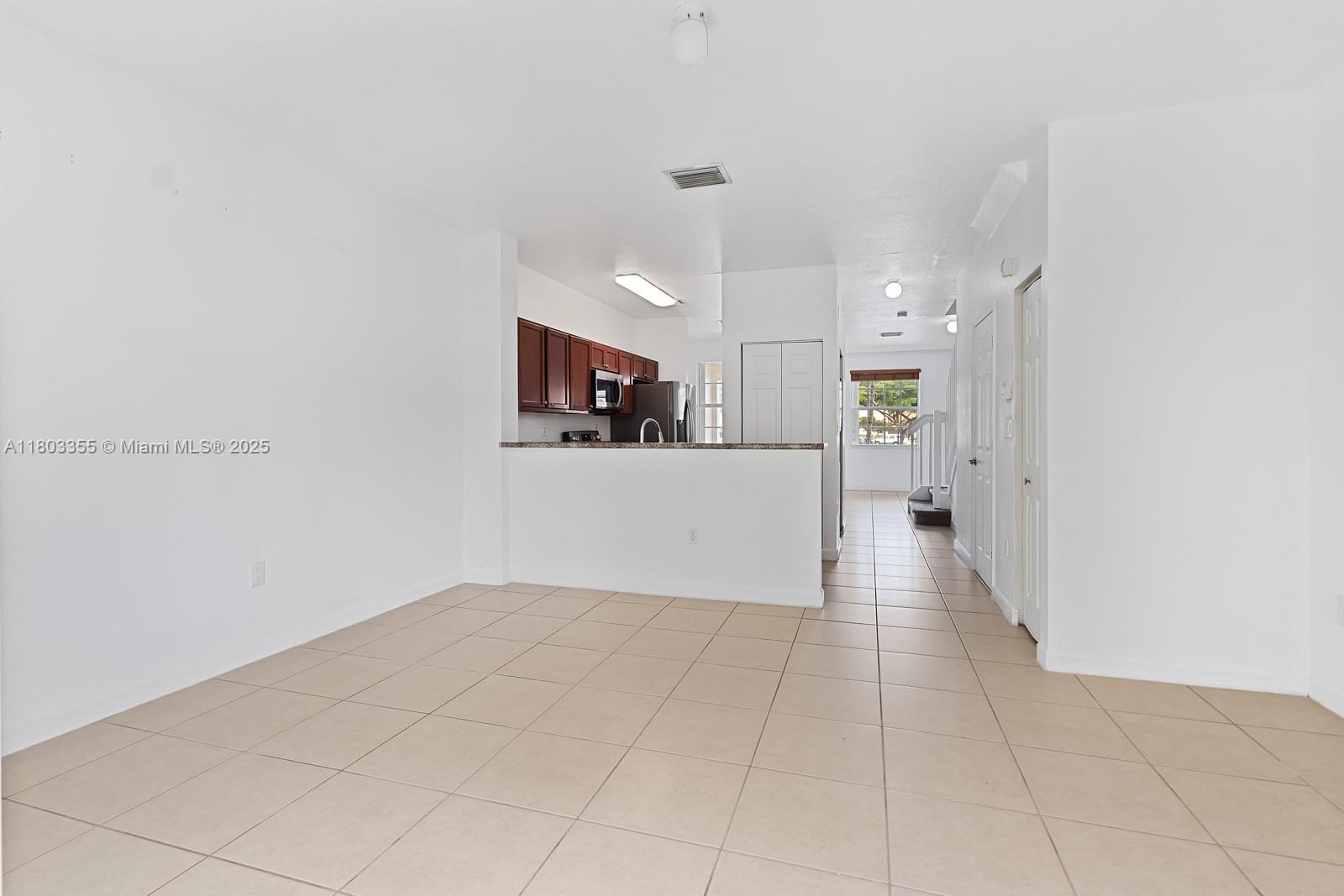 9153 Southwest 227th Street, Unit 3 Cutler Bay, FL 33190 - Photo 10 of 32 a view of a kitchen with a sink and a refrigerator