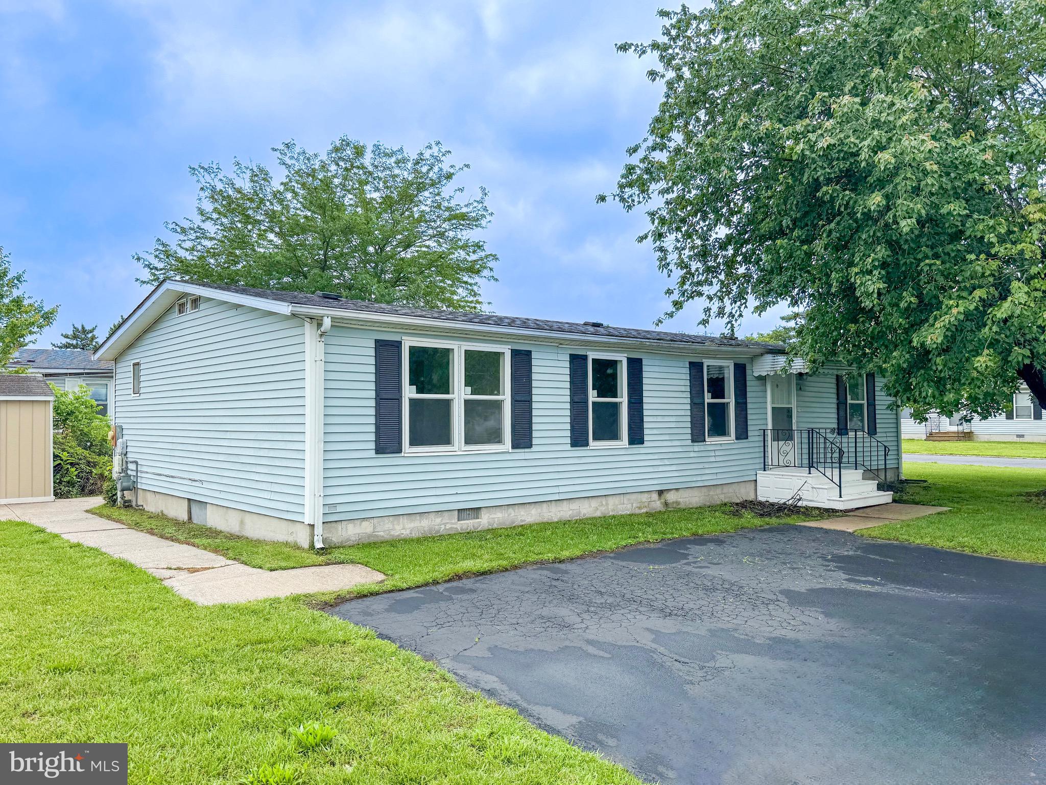 a front view of a house with a yard table and chairs