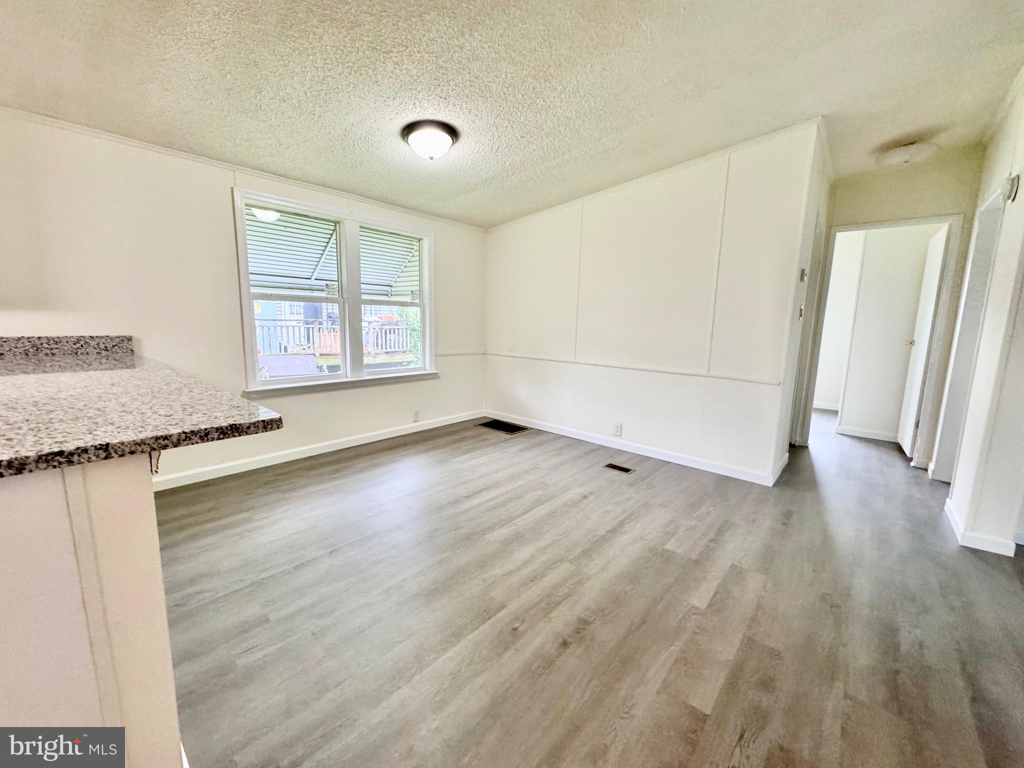 4 Welch Drive Dover, DE 19901 - Photo 12 of 22 an empty room with wooden floor and windows