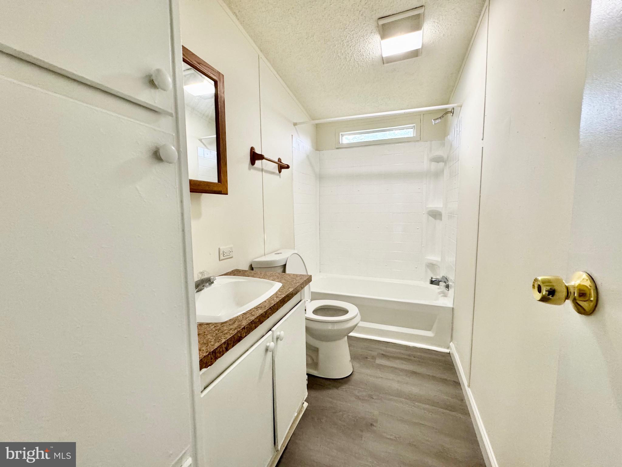 4 Welch Drive Dover, DE 19901 - Photo 20 of 22 a bathroom with a granite countertop sink a toilet and shower