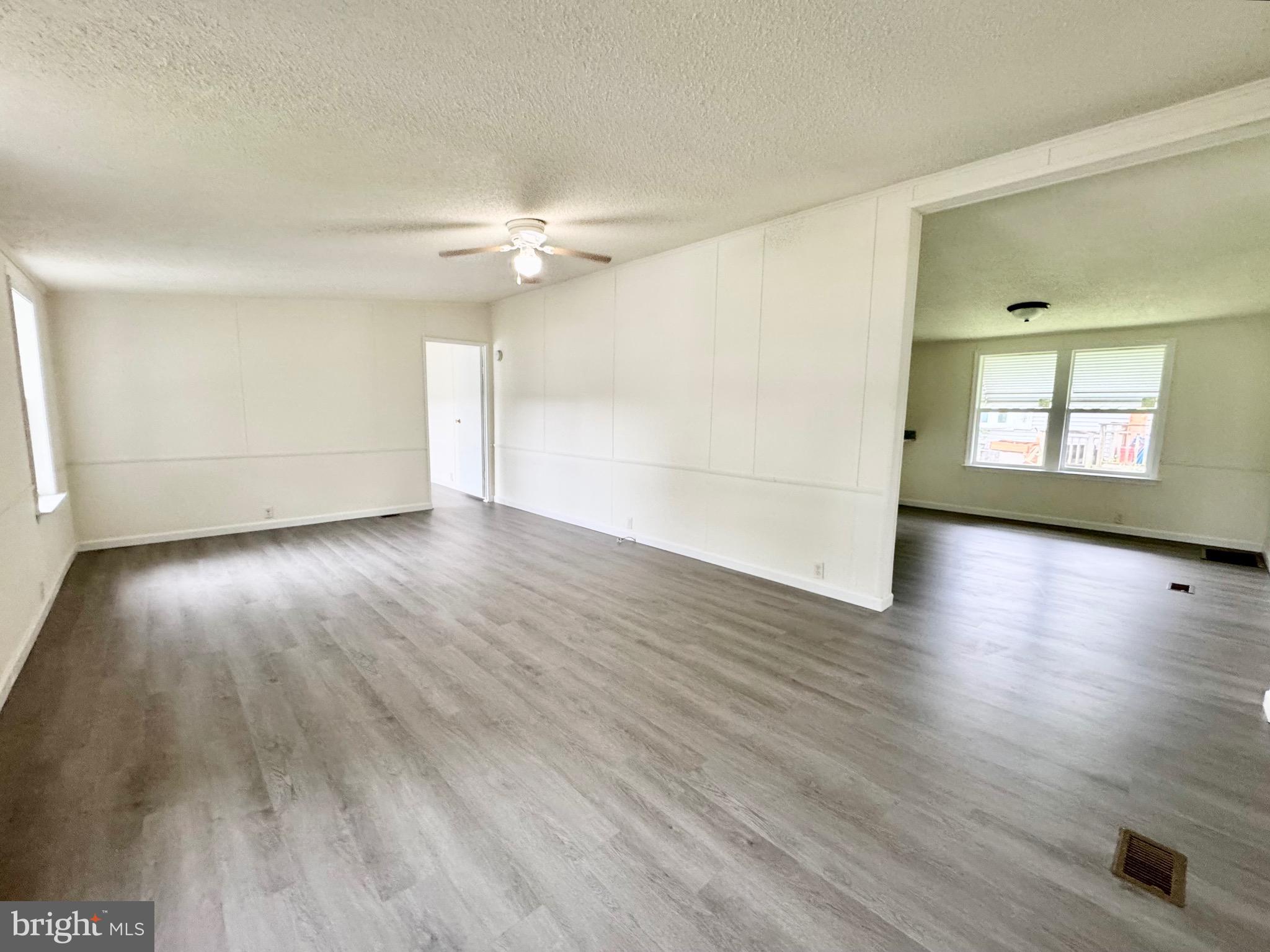 4 Welch Drive Dover, DE 19901 - Photo 2 of 22 an empty room with wooden floor and windows