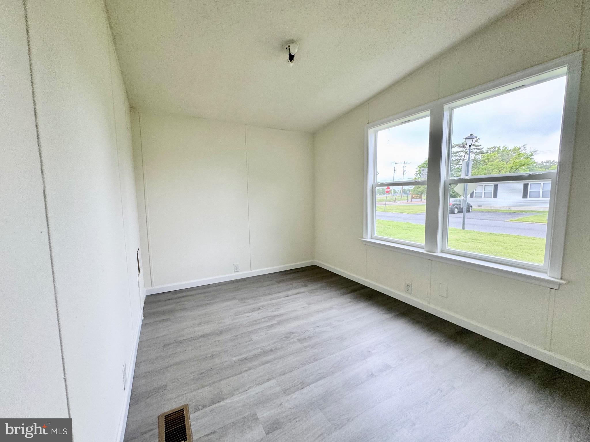 4 Welch Drive Dover, DE 19901 - Photo 21 of 22 a view of an empty room with wooden floor and a window