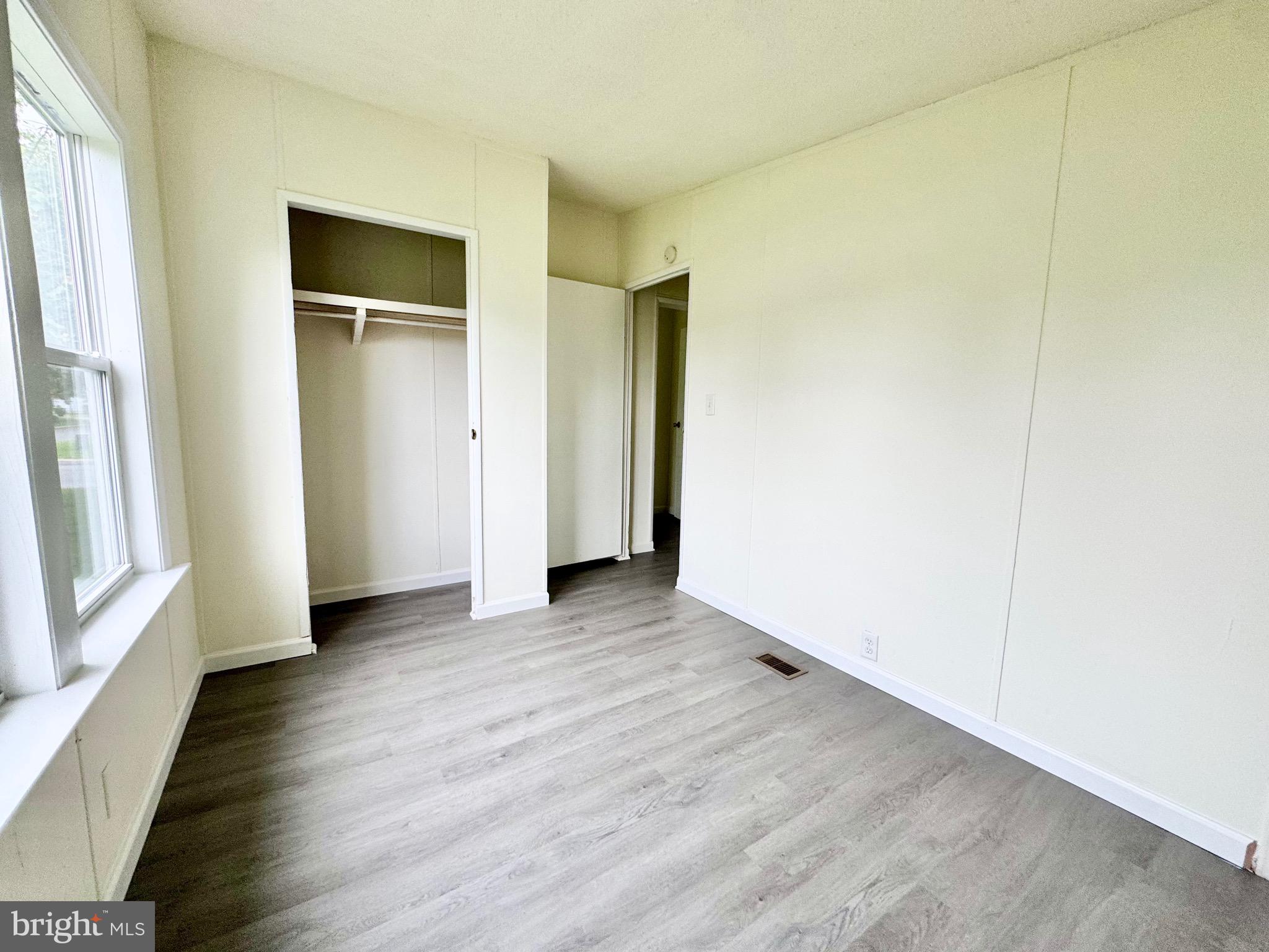 4 Welch Drive Dover, DE 19901 - Photo 22 of 22 an empty room with wooden floor and windows