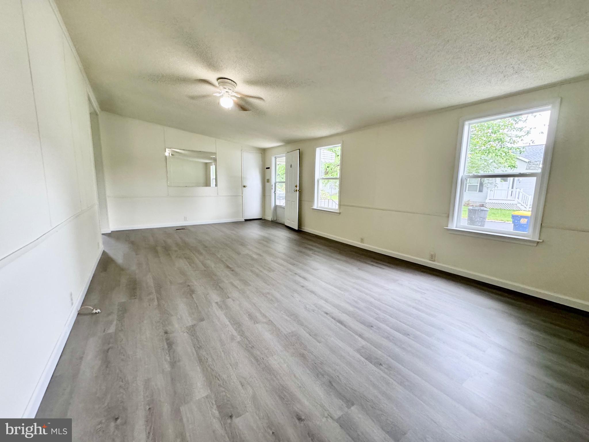 4 Welch Drive Dover, DE 19901 - Photo 4 of 22 an empty room with wooden floor and windows