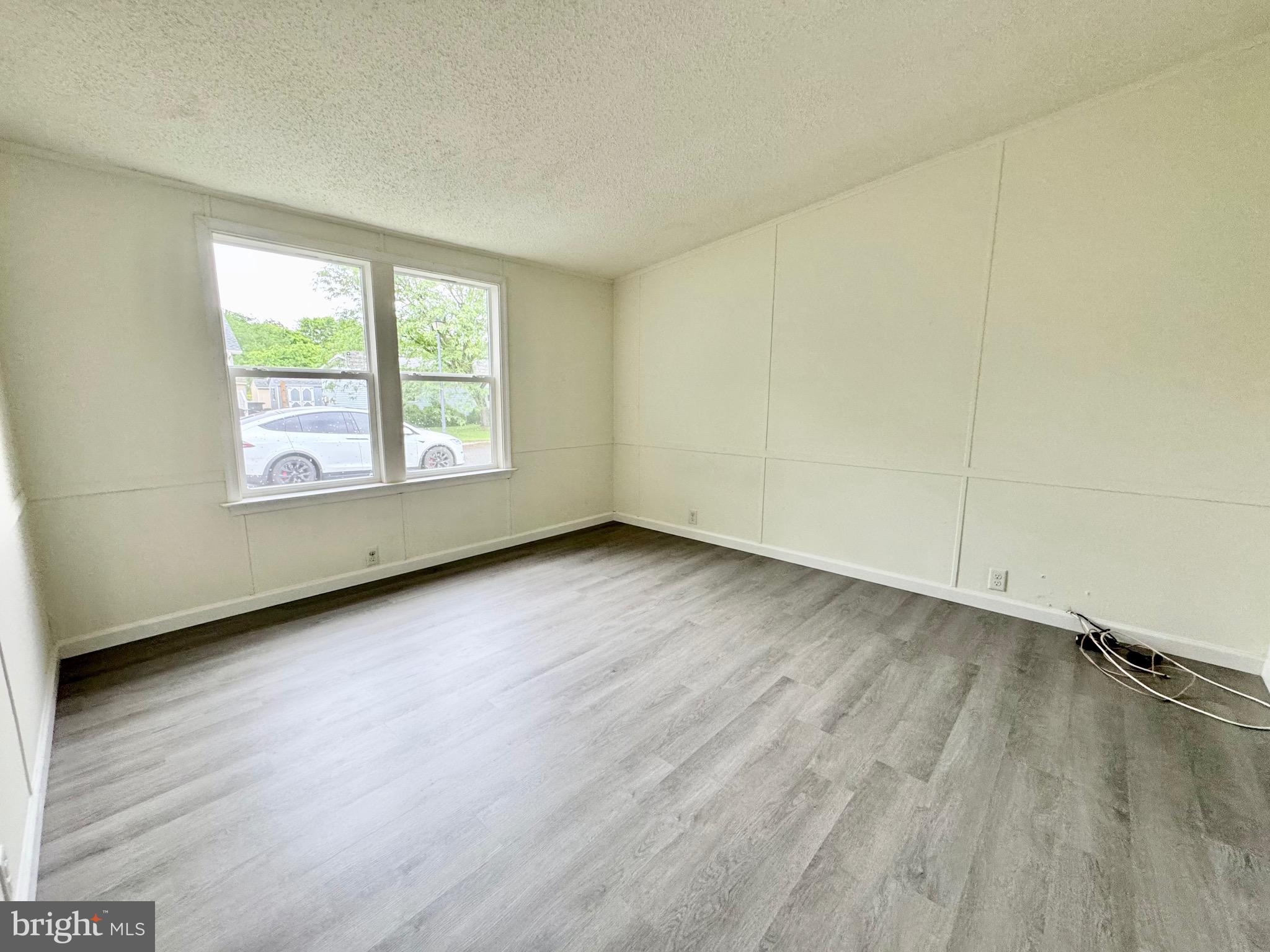 4 Welch Drive Dover, DE 19901 - Photo 5 of 22 an empty room with wooden floor and windows