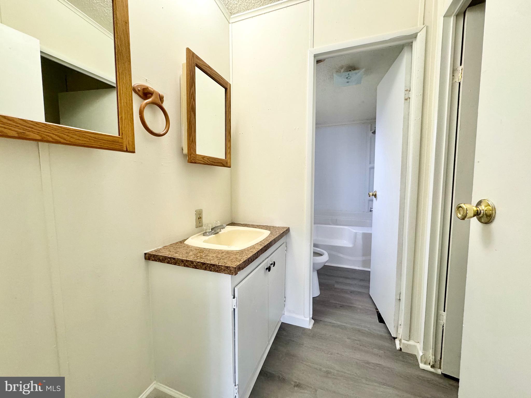 4 Welch Drive Dover, DE 19901 - Photo 8 of 22 a bathroom with a granite countertop sink and a mirror