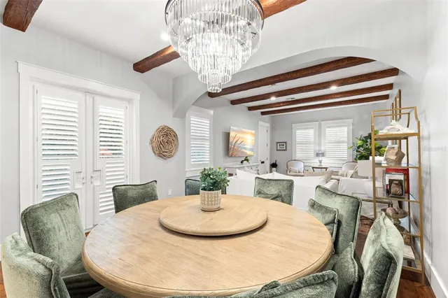 a dining room with furniture and a window