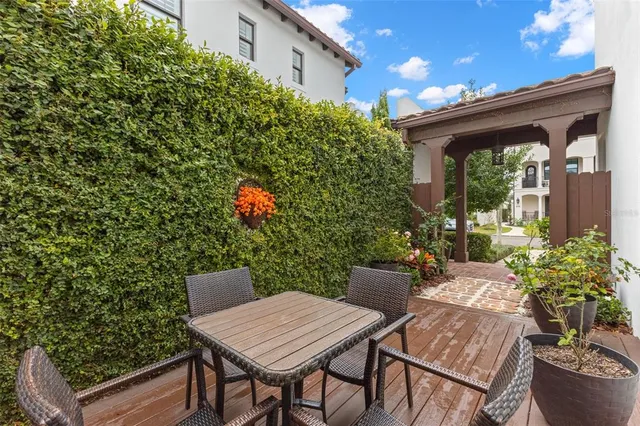 a view of a patio with table and chairs and potted plants