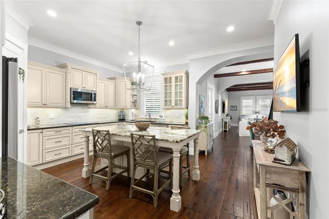 a kitchen with a table chairs stove and cabinets