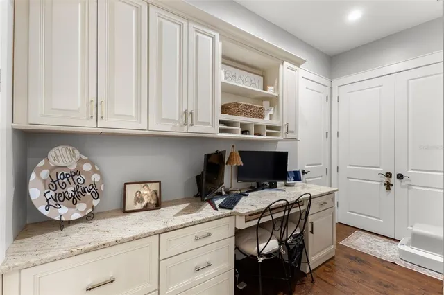 a view of workspace with wooden floor and cabinet