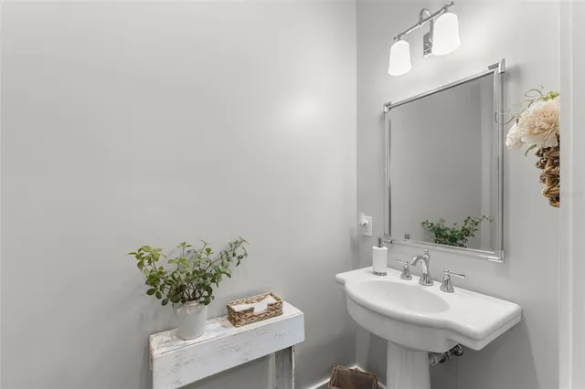 a bathroom with a sink a mirror and a toilet