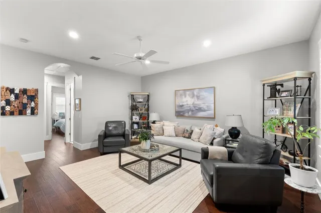 a living room with furniture and wooden floor