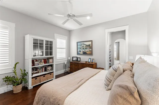 a bedroom with a large bed and a chandelier