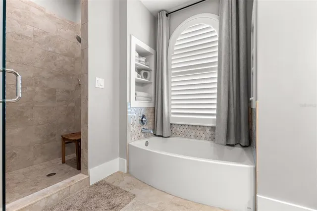 a bathroom with a bathtub and a shower