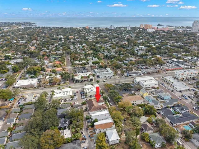 an aerial view of residential building with green space