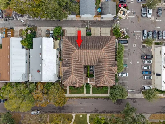 an aerial view of multiple houses with a yard