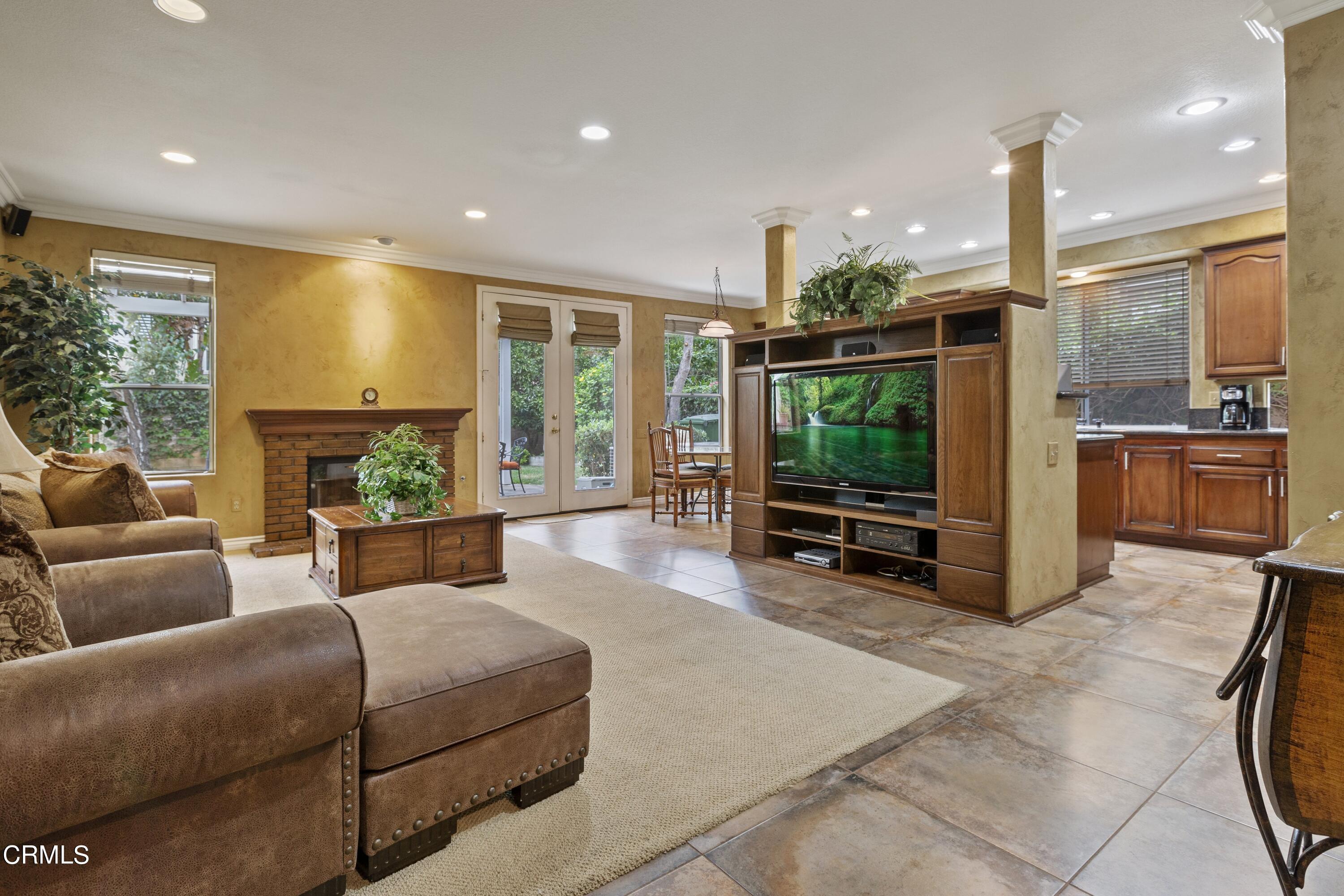 11774 Pinedale Road Moorpark, CA 93021 - Photo 15 of 37 a living room with furniture a floor to ceiling window and kitchen view