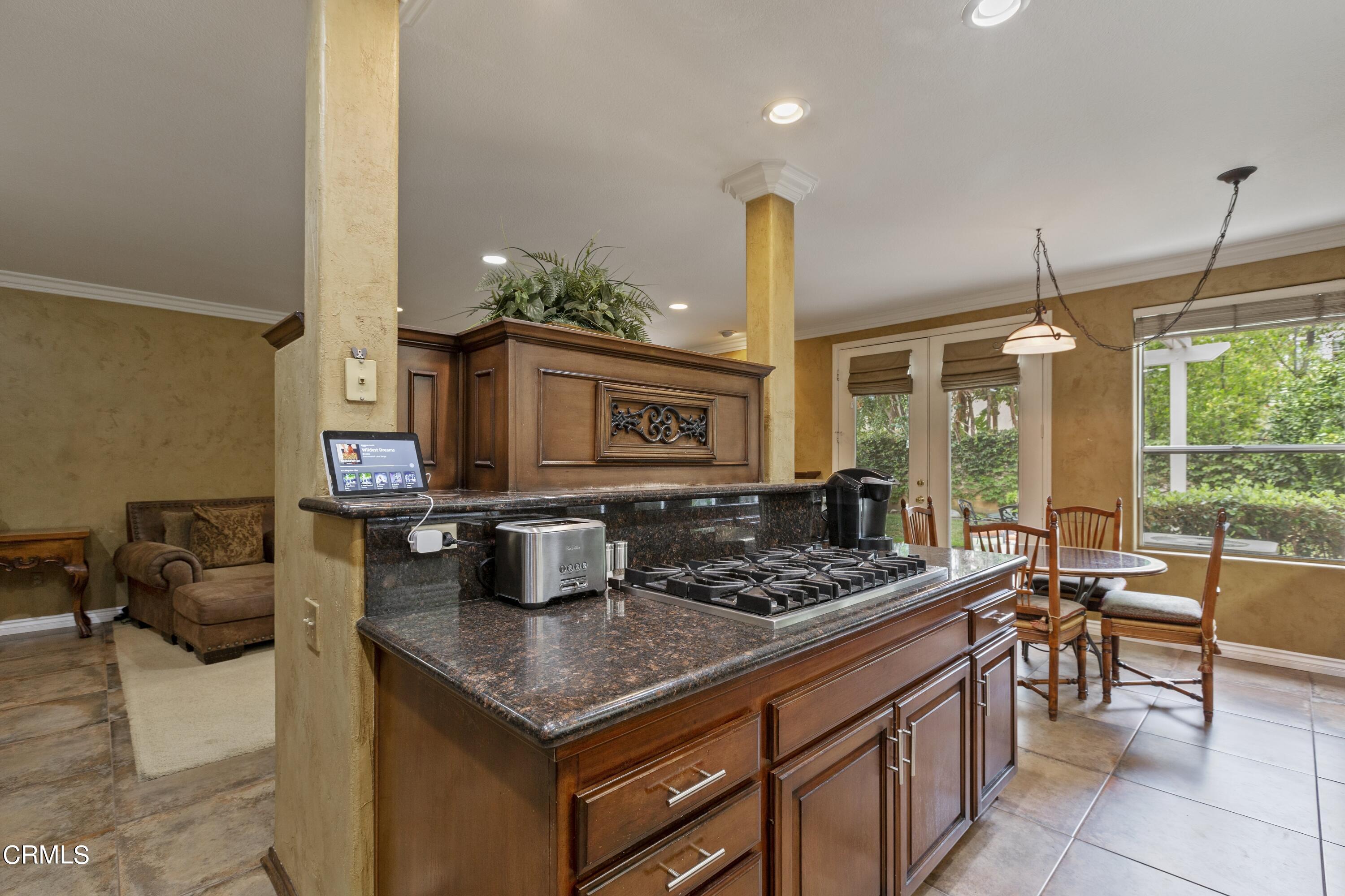 11774 Pinedale Road Moorpark, CA 93021 - Photo 20 of 37 a kitchen with stainless steel appliances granite countertop a stove and a view of living room