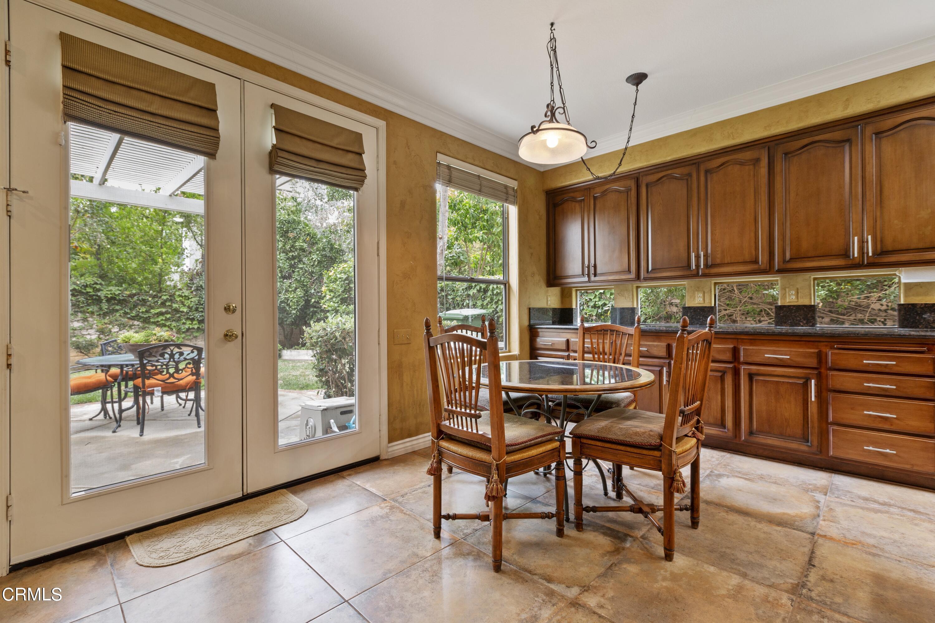 11774 Pinedale Road Moorpark, CA 93021 - Photo 21 of 37 a kitchen that has a cabinets counter space dining table and a large window