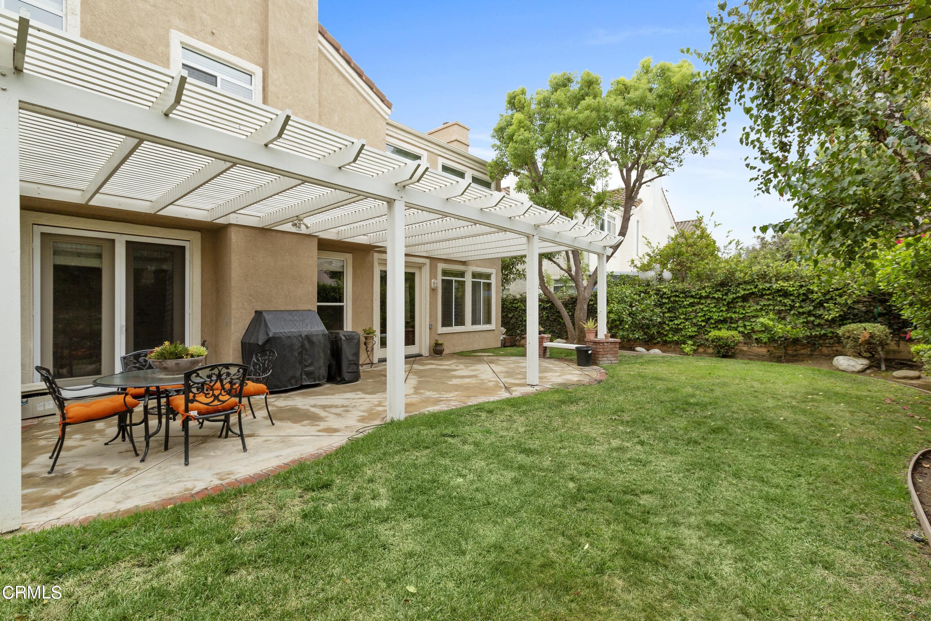 11774 Pinedale Road Moorpark, CA 93021 - Photo 34 of 37 a view of a patio with table and chairs under an umbrella