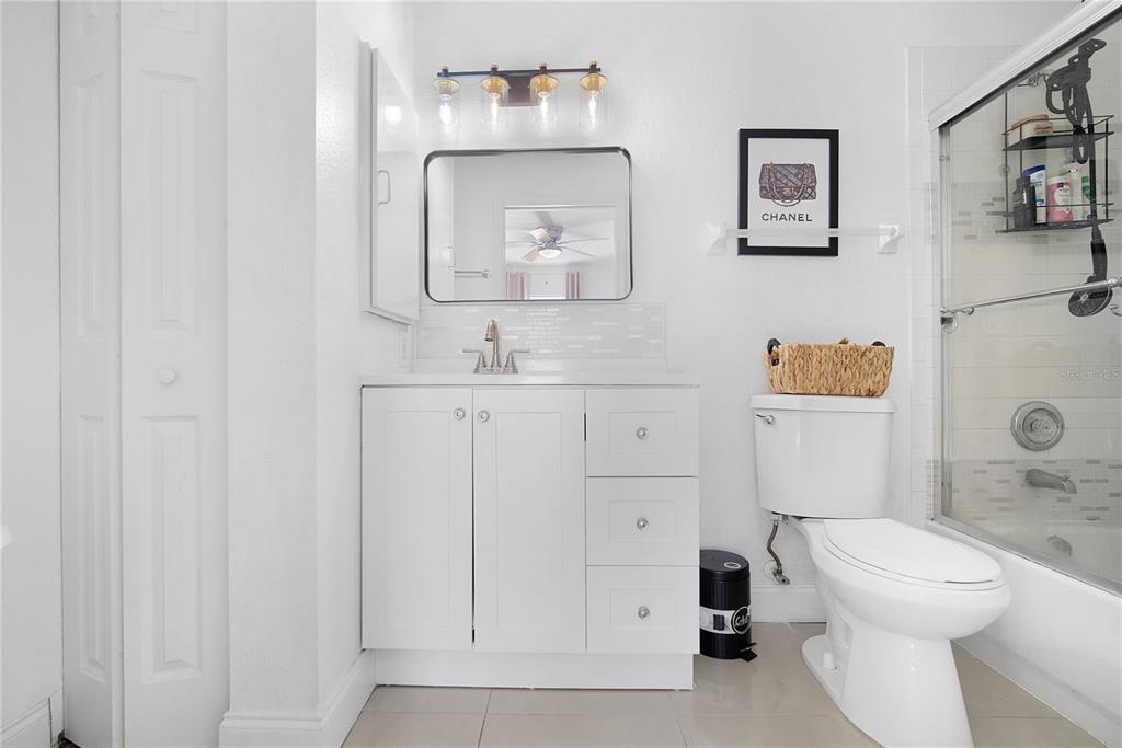 16285 Southwest 21st Court Ocala, FL 34473 - Photo 17 of 40 a bathroom with a toilet sink vanity and mirror