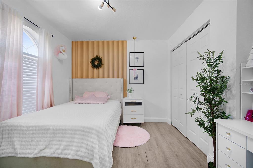 16285 Southwest 21st Court Ocala, FL 34473 - Photo 20 of 40 a bedroom with a bed and a potted plant