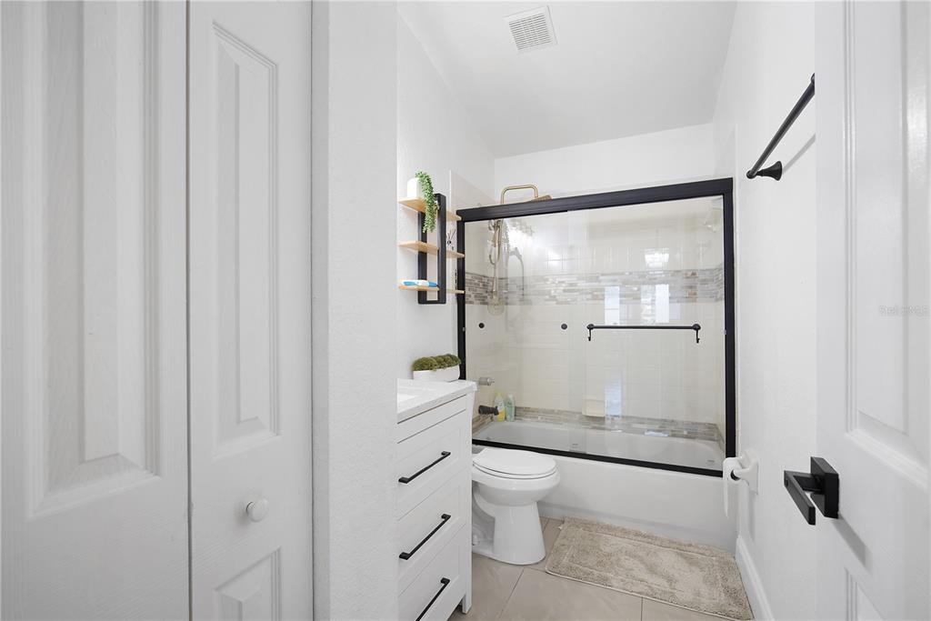 16285 Southwest 21st Court Ocala, FL 34473 - Photo 23 of 40 a bathroom with a glass shower door