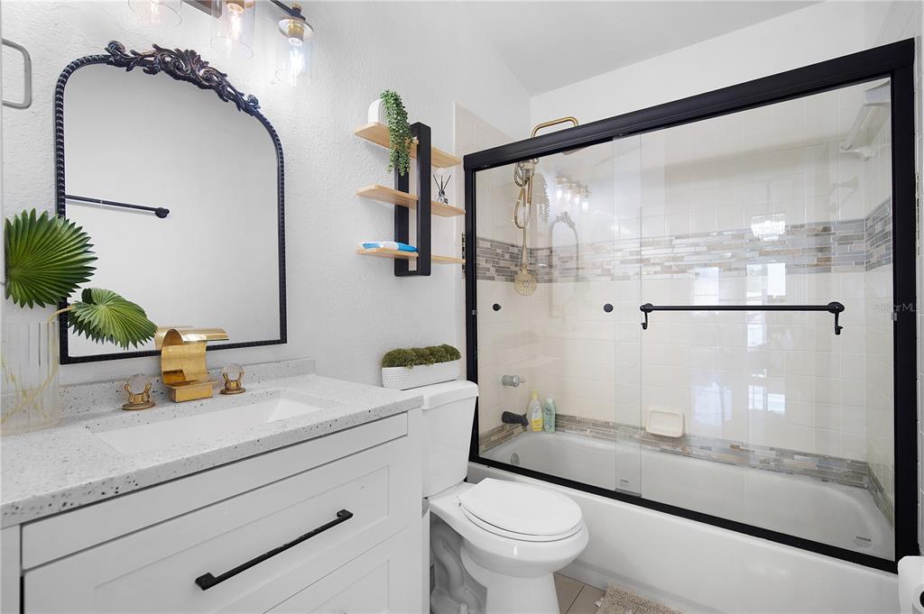 16285 Southwest 21st Court Ocala, FL 34473 - Photo 25 of 40 a bathroom with a sink a mirror and a shower