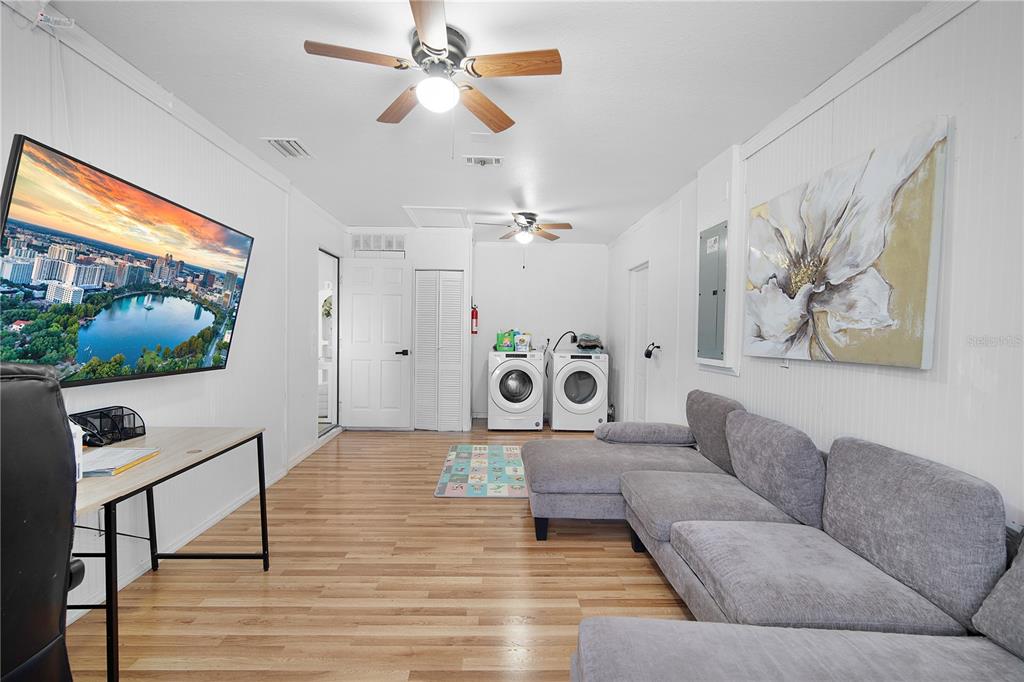 16285 Southwest 21st Court Ocala, FL 34473 - Photo 27 of 40 a living room with furniture and a flat screen tv