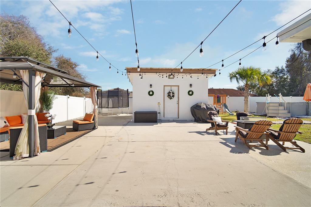 16285 Southwest 21st Court Ocala, FL 34473 - Photo 31 of 40 a view of a patio with table and chairs with wooden floor
