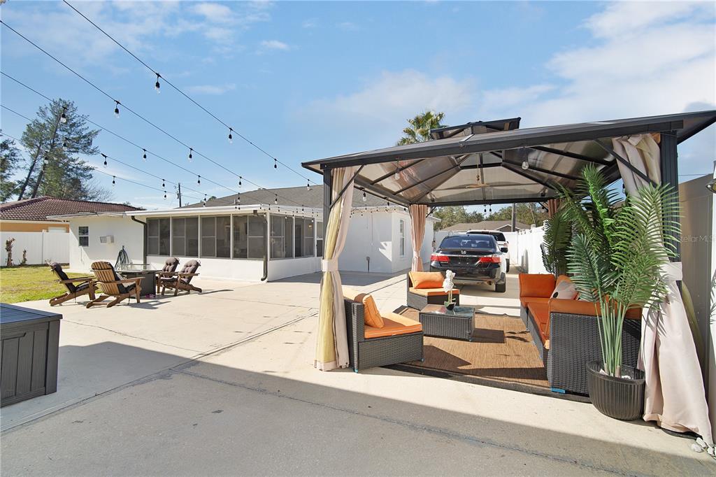 16285 Southwest 21st Court Ocala, FL 34473 - Photo 34 of 40 a view of a patio with a table and chairs under an umbrella