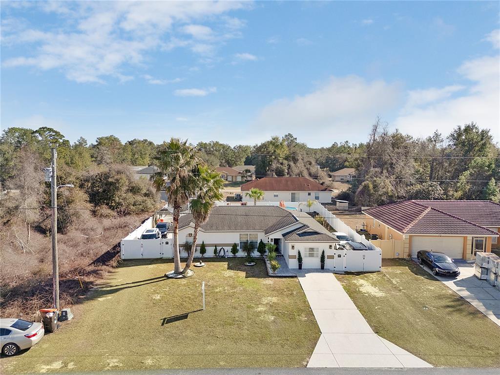 16285 Southwest 21st Court Ocala, FL 34473 - Photo 37 of 40 an aerial view of a house with a big yard and large trees